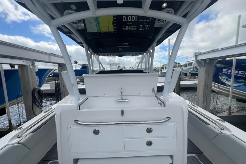 Slide: The Image of 2024 Nor-Tech 392 Super Fish boat interior with navigation display and storage compartments. - 3