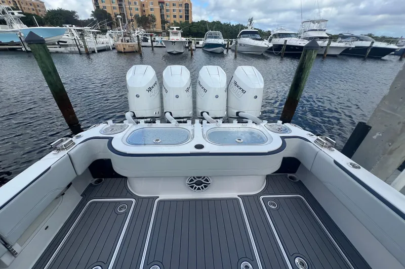 Slide: The Image of 2024 Nor-Tech 392 Super Fish boat with quad engines docked at marina. - 6