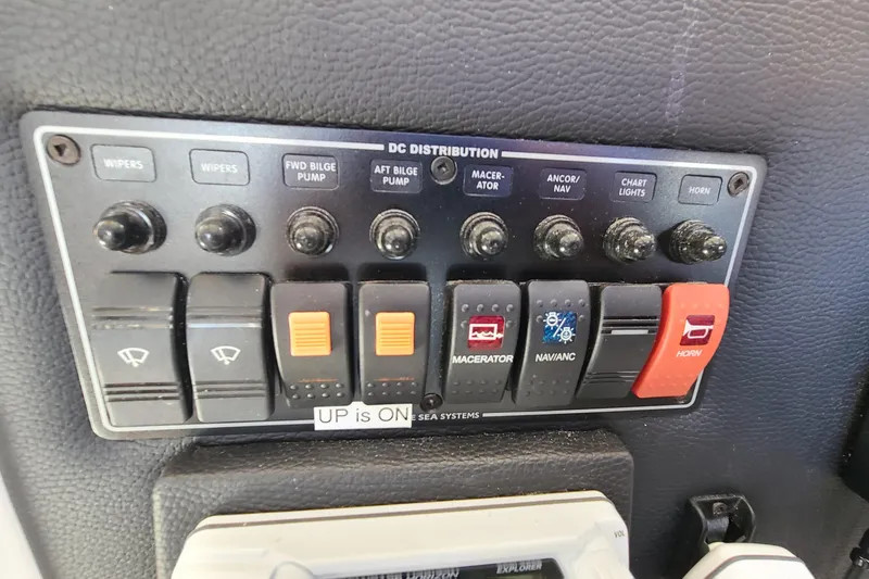 Slide: The Image of Control panel of a 2019 Cutwater C-28 LE boat with labeled switches and buttons. - 16