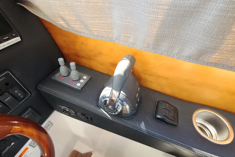 Slide: The Image of 2019 Cutwater C-28 LE boat controls with throttle and joystick, interior view. - 19