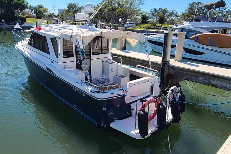 Slide: The Image of 2019 Cutwater C-28 LE docked at marina, featuring sleek design and modern amenities. - 2