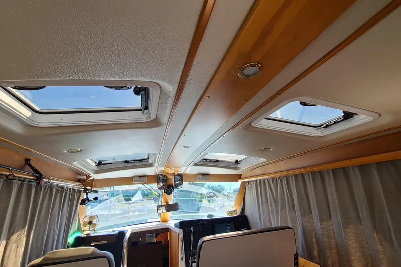 Slide: The Image of Interior view of 2019 Cutwater C-28 LE boat with skylights and wooden accents. - 21
