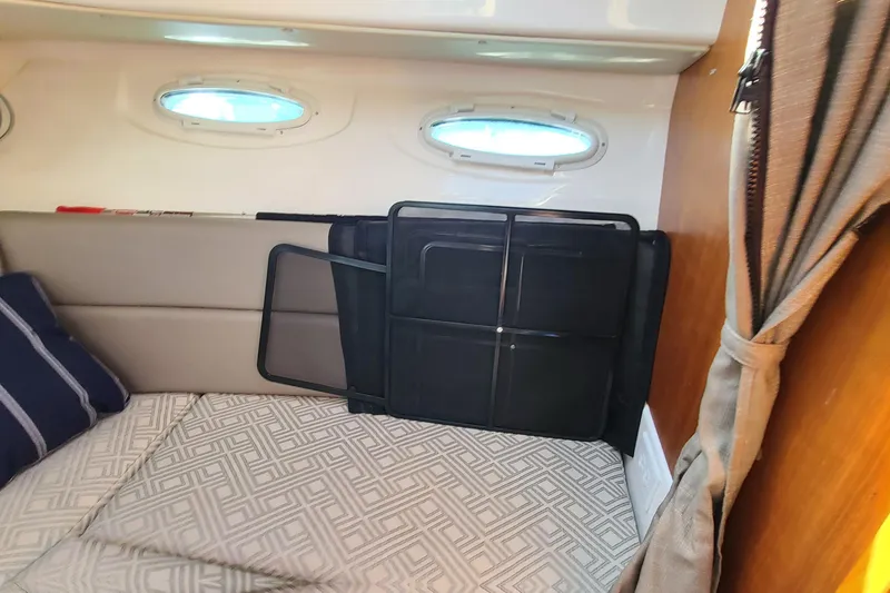 Slide: The Image of 2019 Cutwater C-28 LE cabin interior with bed, windows, and curtain. - 26