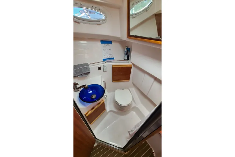 Slide: The Image of 2019 Cutwater C-28 LE boat bathroom with blue sink and toilet. - 27