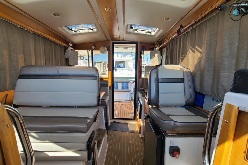 Slide: The Image of Interior of 2019 Cutwater C-28 LE boat with modern seating and wood accents. - 28