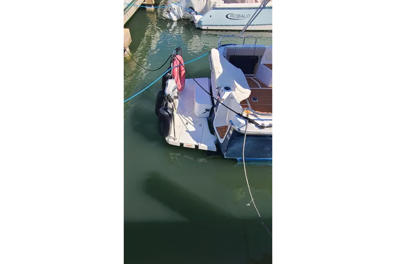 Slide: The Image of 2019 Cutwater C-28 LE boat docked in marina, rear view with deck and ropes. - 29