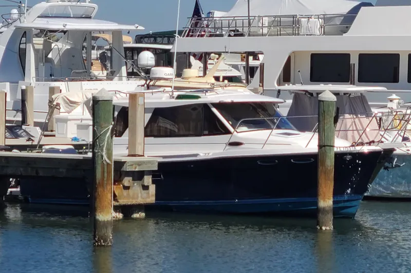 Slide: The Image of 2019 Cutwater C-28 LE boat docked at marina, surrounded by other vessels. - 3