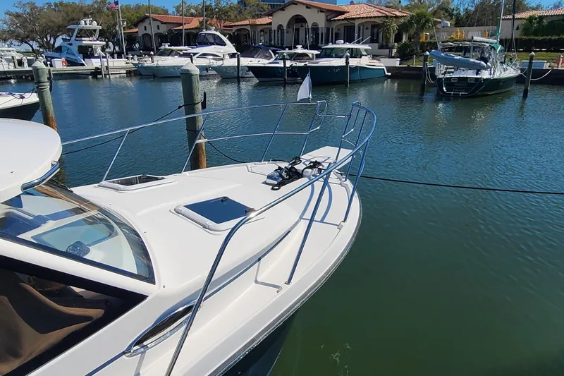 Slide: The Image of 2019 Cutwater C-28 LE boat docked in a marina with other vessels. - 30