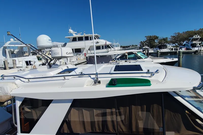 Slide: The Image of 2019 Cutwater C-28 LE boat docked at marina with other vessels. - 31