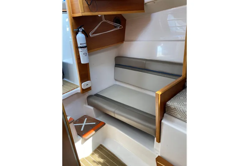 Slide: The Image of 2019 Cutwater C-28 LE interior with seating, fire extinguisher, and wooden accents. - 35