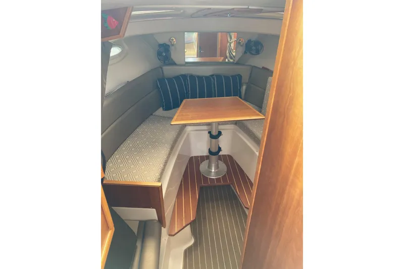 Slide: The Image of 2019 Cutwater C-28 LE cabin interior with seating and wooden table. - 36