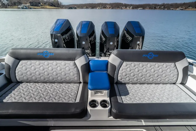 Slide: The Image of 2025 Fountain 43 SCX boat interior with luxurious seating and powerful outboard engines on a serene lake. - 16
