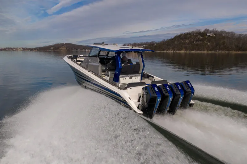 Slide: The Image of 2025 Fountain 43 SCX speedboat with quad engines cruising on a calm lake. - 3