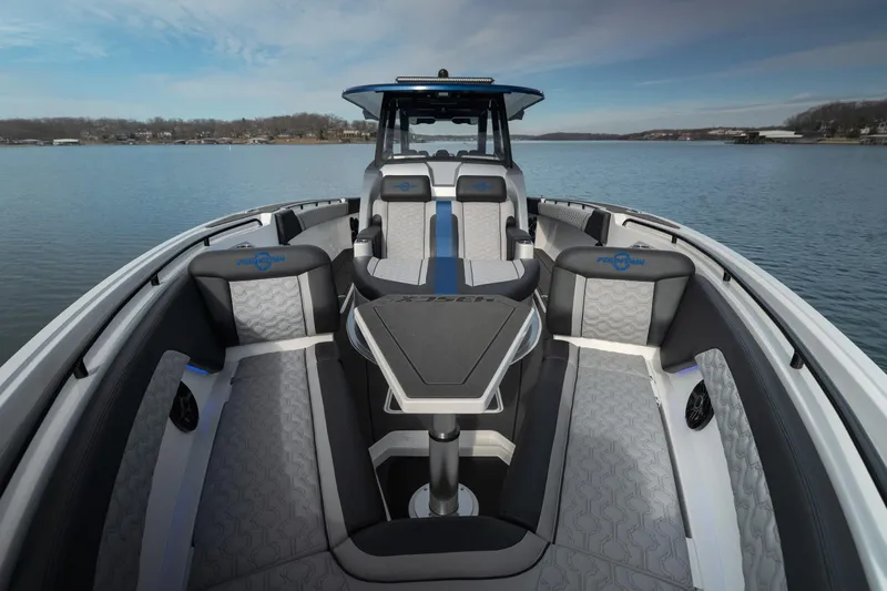 Slide: The Image of 2025 Fountain 43 SCX boat interior with modern seating on a calm lake. - 30