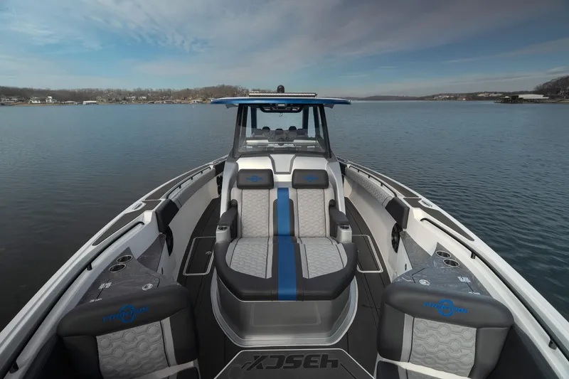 Slide: The Image of 2025 Fountain 43 SCX boat interior with luxurious seating on a calm lake. - 32