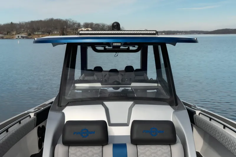 Slide: The Image of 2025 Fountain 43 SCX boat on calm lake, showcasing sleek design and modern features. - 33