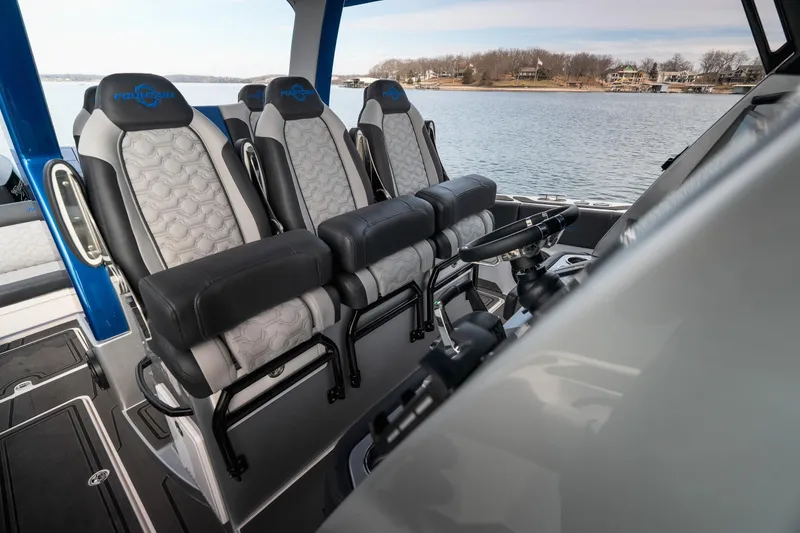 Slide: The Image of 2025 Fountain 43 SCX boat interior with luxury seating and steering, overlooking serene water. - 35