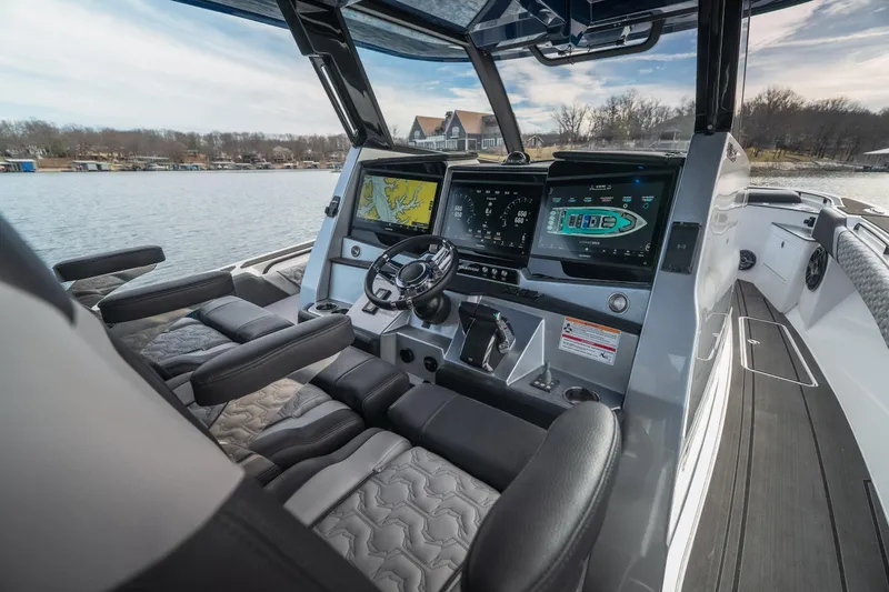 Slide: The Image of 2025 Fountain 43 SCX boat interior with advanced navigation and control systems on a serene lake. - 36
