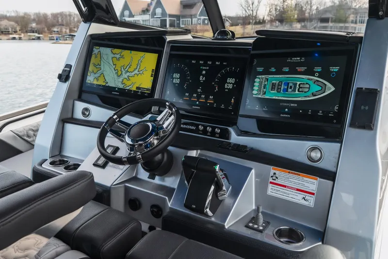 Slide: The Image of 2025 Fountain 43 SCX boat dashboard with advanced navigation displays and controls. - 37