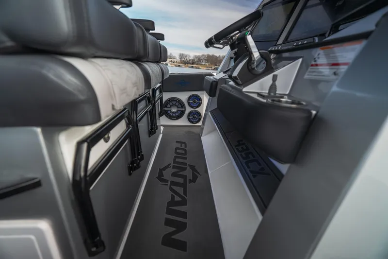 Slide: The Image of 2025 Fountain 43 SCX boat interior with steering wheel and seating, showcasing modern design. - 38