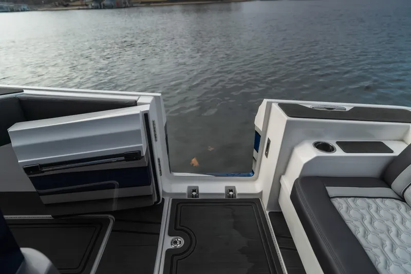 Slide: The Image of 2025 Fountain 43 SCX boat interior with open door, overlooking calm water. - 39