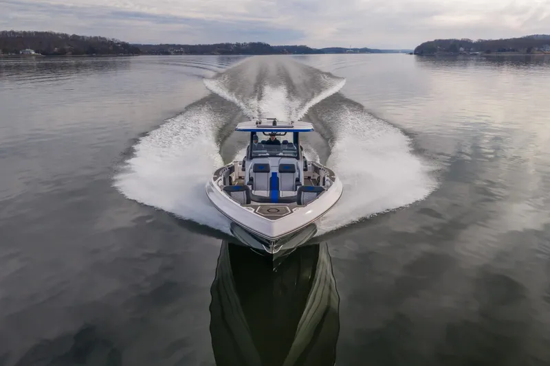 Slide: The Image of 2025 Fountain 43 SCX speedboat cruising on a calm lake, creating a dynamic wake. - 6