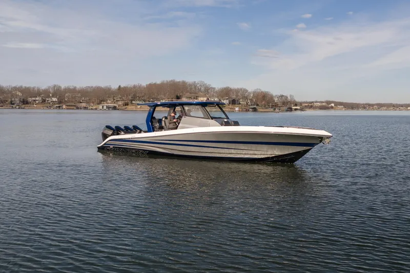 Slide: The Image of 2025 Fountain 43 SCX boat on calm water under a clear sky. - 7