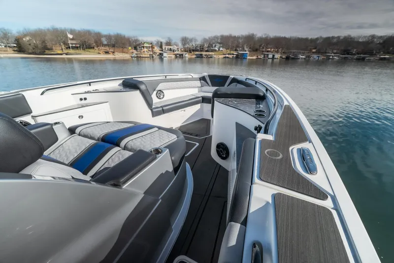 Slide: The Image of 2025 Fountain 43 SCX boat interior with sleek seating and modern design on a calm lake. - 8