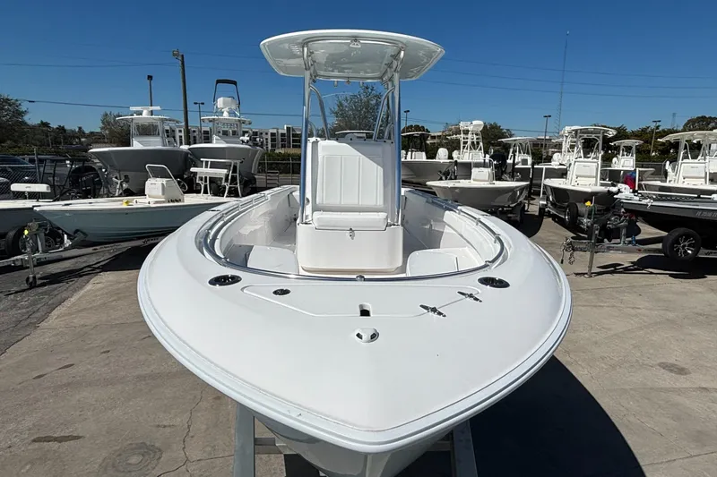 Slide: The Image of 2026 Contender 24 Sport boat displayed in a marina, surrounded by other vessels. - 10