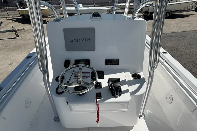 Slide: The Image of 2026 Contender 24 Sport boat console with Garmin navigation system and steering wheel. - 6