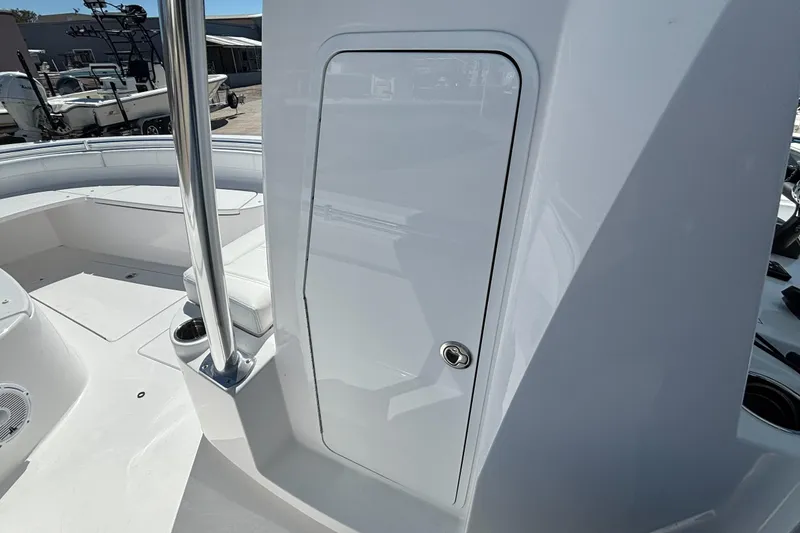Slide: The Image of 2026 Contender 24 Sport boat interior with sleek white design and storage compartment. - 7