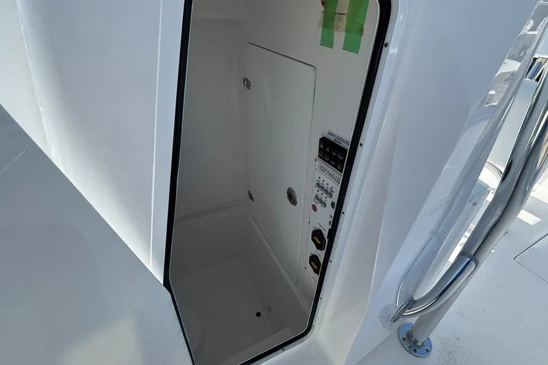 Slide: The Image of 2026 Contender 24 Sport boat interior with control panel and storage area. - 8