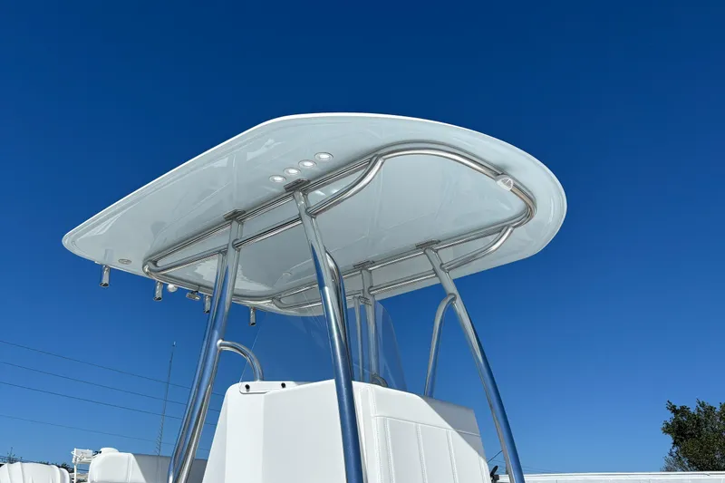 Slide: The Image of 2026 Contender 24 Sport boat with sleek T-top against clear blue sky. - 9