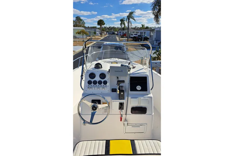Slide: The Image of 2002 Pro-Line 20 Sport boat dashboard with steering wheel and navigation instruments. - 3