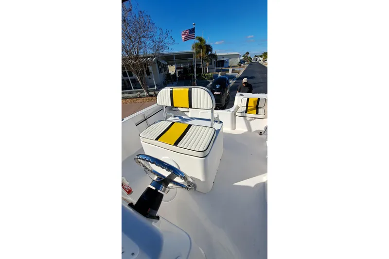 Slide: The Image of 2002 Pro-Line 20 Sport boat interior with striped seating and steering wheel. - 5