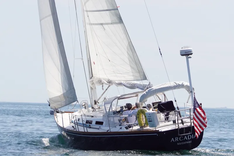 Slide: The Image of 1997 J Boats J/42 sailboat on open water. - 10