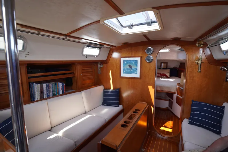 Slide: The Image of Interior of 1997 J Boats J/42 sailboat with cozy seating and wooden finish. - 34
