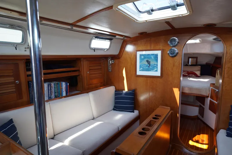 Slide: The Image of Interior of a 1997 J/42 yacht with cozy sofa and wood finish. - 35