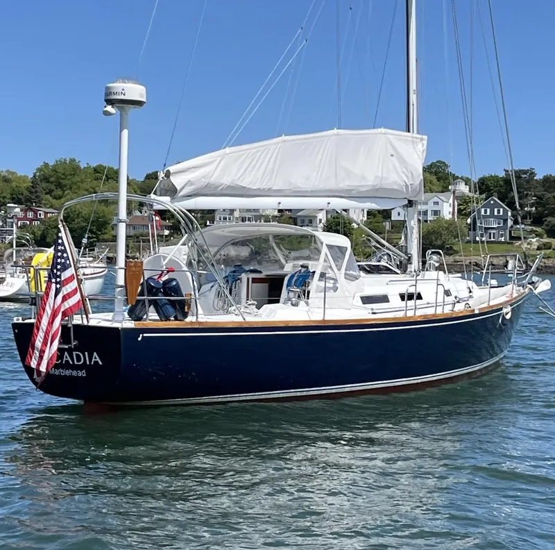 Slide: The Image of 1997 J Boats J/42 sailboat in harbor with American flag. - 4