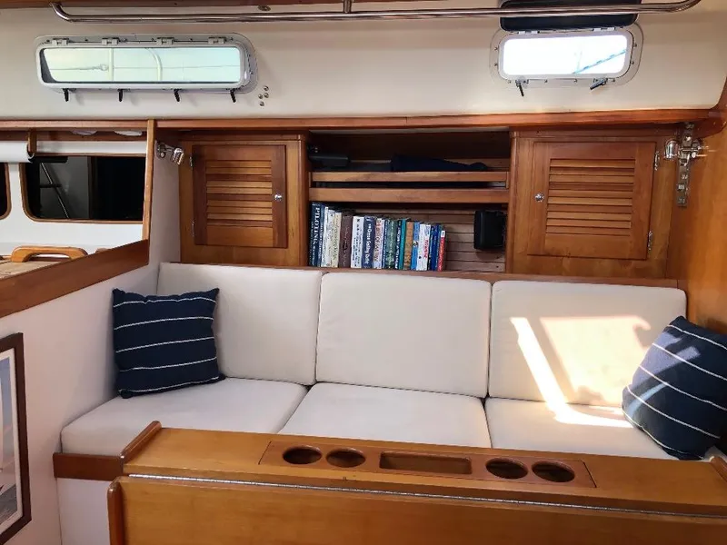 Slide: The Image of Interior of a 1997 J/42 yacht with cozy sofa and bookshelf. - 41