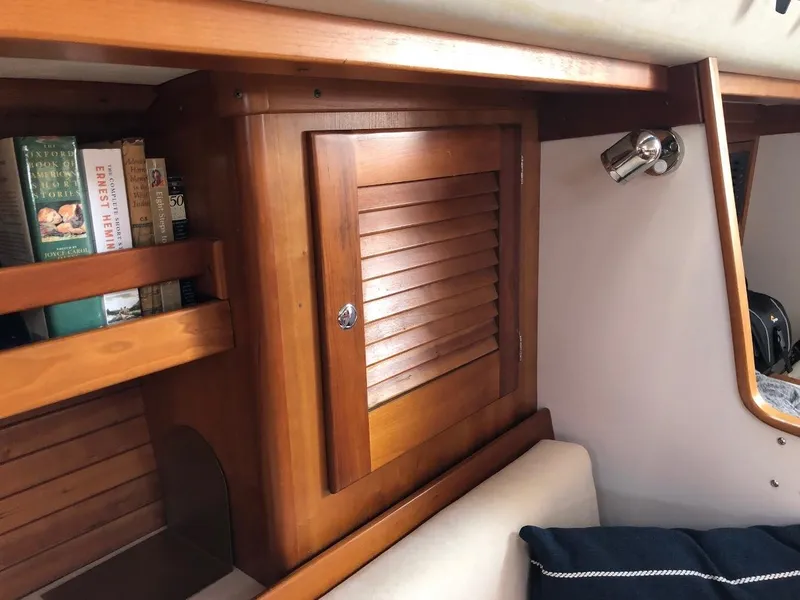Slide: The Image of Interior of a 1997 J/42 yacht with wooden cabinet and bookshelf. - 43