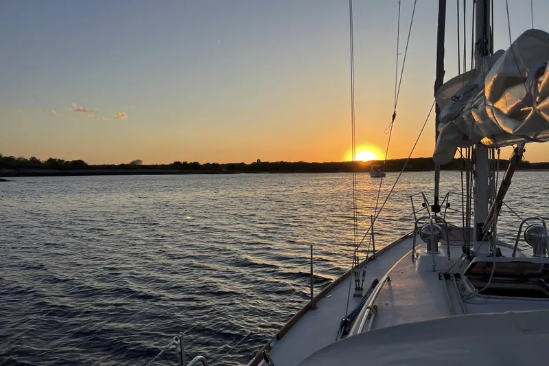 Slide: The Image of Sailing on a 1997 J Boats J/42 at sunset over calm waters. - 64