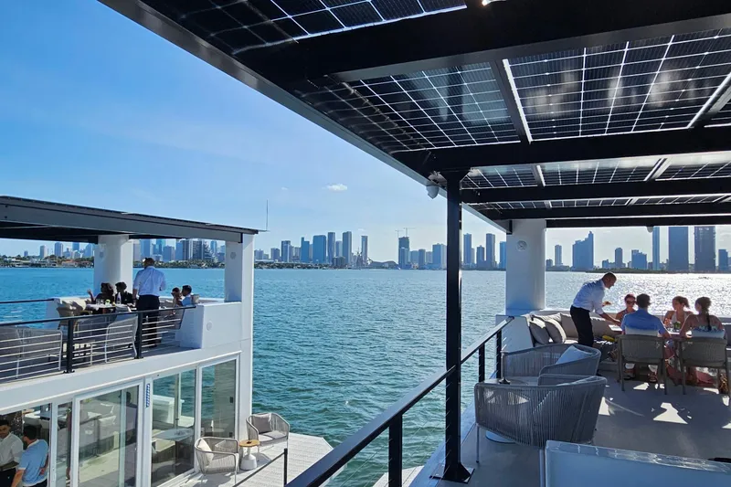 Slide: The Image of Floating ARKHAUS Villa 50, 2025 model, with solar panels and city skyline view. - 6