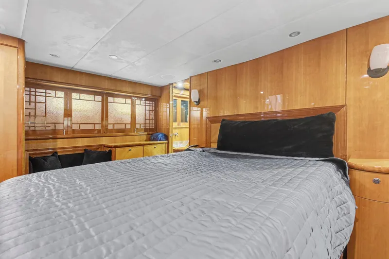 Slide: The Image of Luxurious bedroom interior of 2004 Queenship 76 Baretta yacht with wood paneling and modern design. - 12