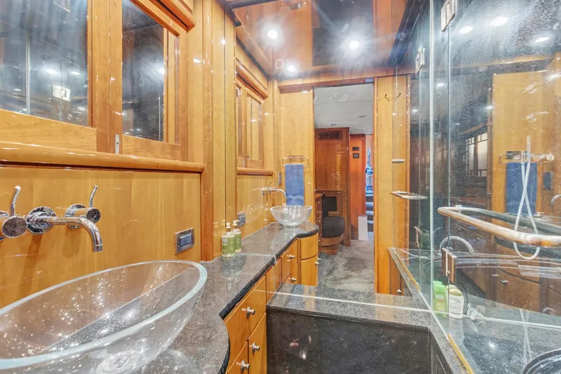 Slide: The Image of Luxurious bathroom in 2004 Queenship 76 Baretta yacht with glass sinks and wooden cabinetry. - 15