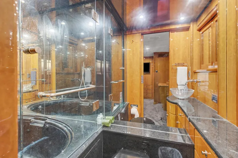 Slide: The Image of Luxurious bathroom in 2004 Queenship 76 Baretta yacht with glass shower and modern fixtures. - 16