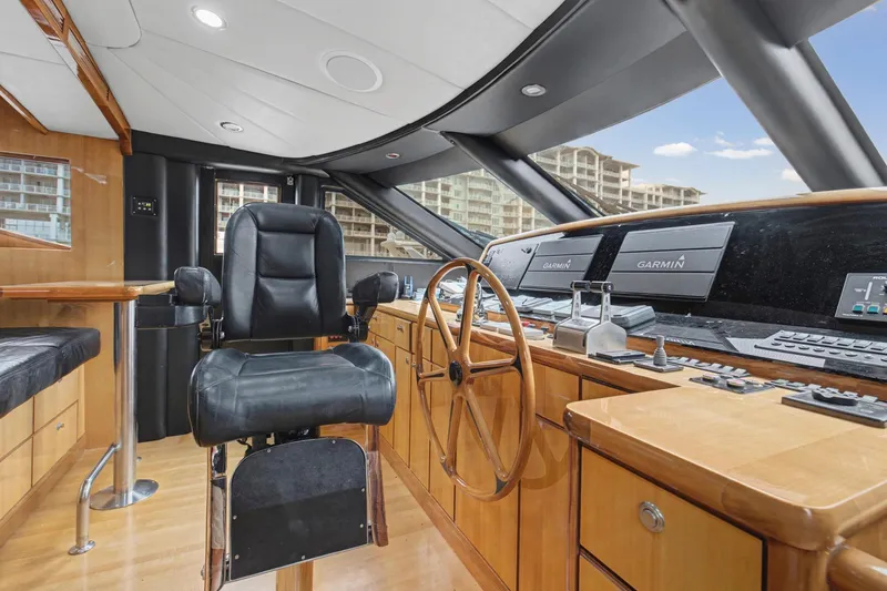 Slide: The Image of Luxurious 2004 Queenship 76 Baretta yacht helm with leather chair and advanced navigation systems. - 19