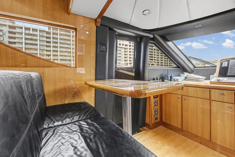 Slide: The Image of Luxurious interior of 2004 Queenship 76 Baretta yacht with leather seating and wooden cabinetry. - 20