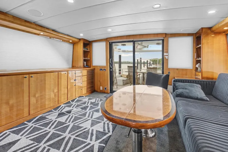Slide: The Image of Luxurious interior of 2004 Queenship 76 Baretta yacht with elegant wood finishes and modern furnishings. - 26