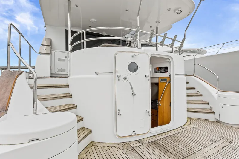 Slide: The Image of 2004 Queenship 76 Baretta yacht deck with open cabin door and wooden steps. - 38